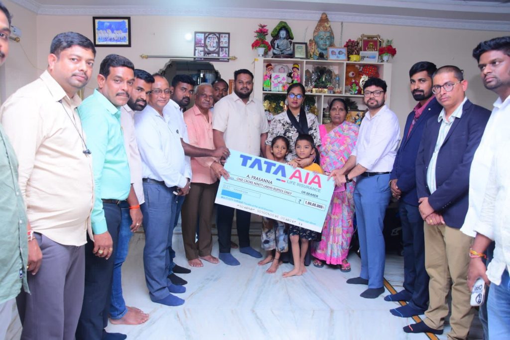 Group of people at Tata AIA term insurance claim ceremony handing over a large cheque of ₹1.90 crores